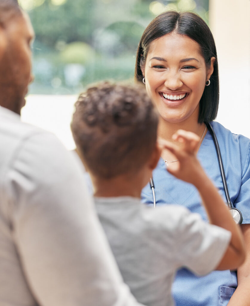 Smiling nurse greeting young patient and family.